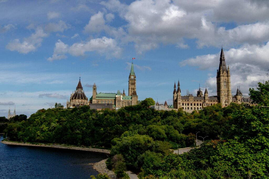 Parliament Hill and Library of Parliament as viewed from the Ottawa River Parkway. Photograph by Chris DeSort, Unsplash.